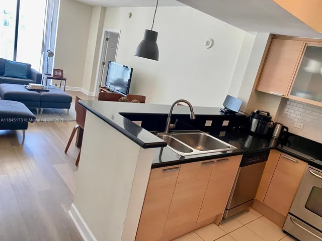 a view of a living room with furniture and wooden floor