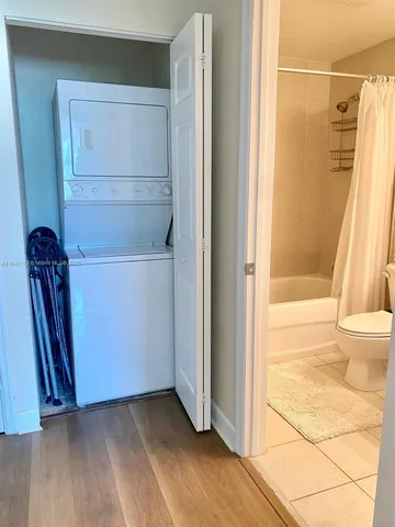 a view of front door with hallway and closet