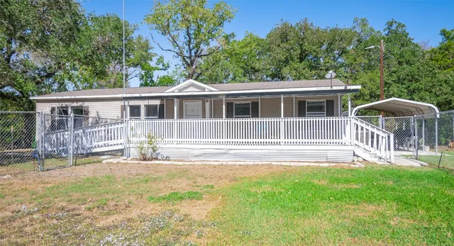 a front view of a house with a yard table and chairs
