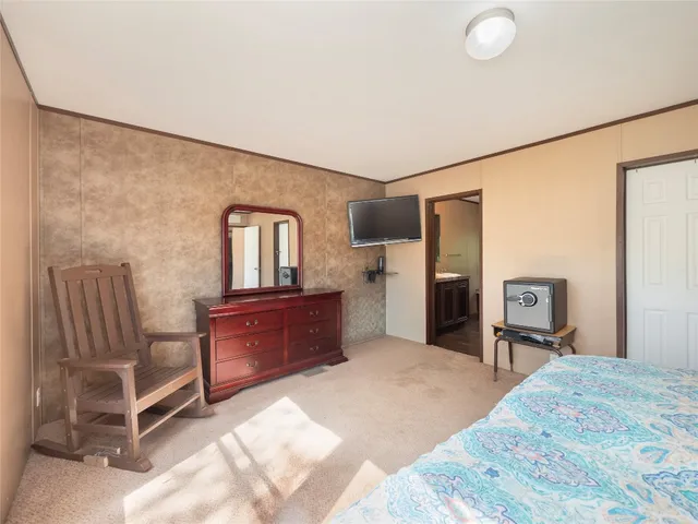 a bedroom with a bed and a dresser in it