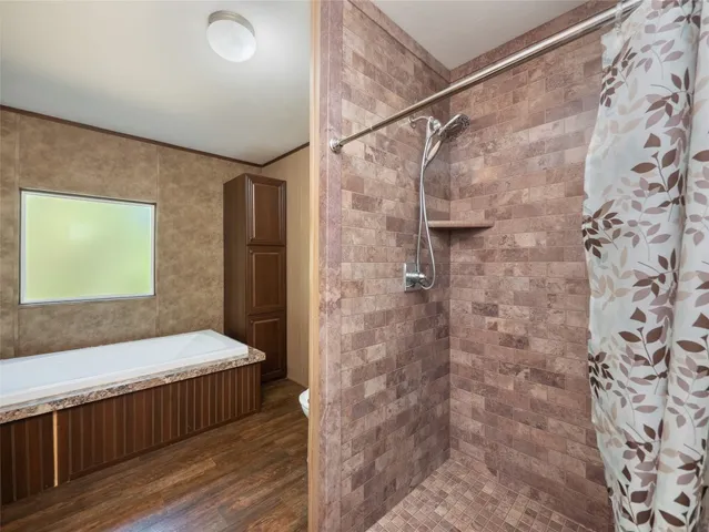 a bathroom with a bathtub and shower