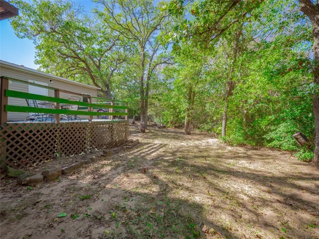 a view of a house with backyard and a tree