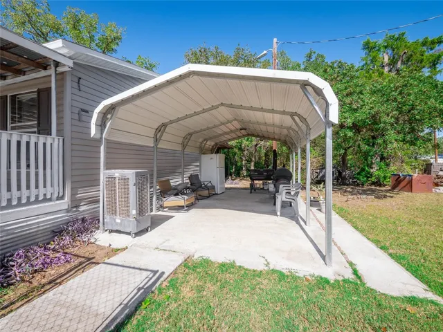 a front view of a house with swimming pool having outdoor seating