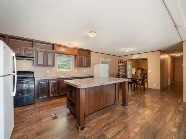 a kitchen with stainless steel appliances granite countertop a stove and a refrigerator