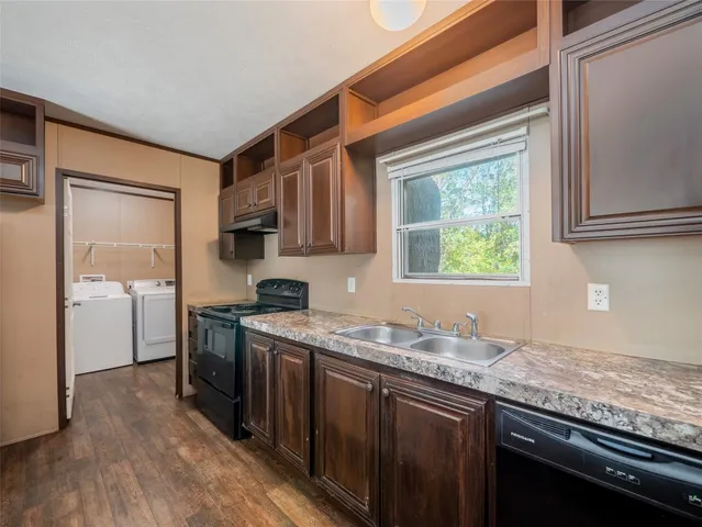 a kitchen with stainless steel appliances granite countertop wooden cabinets a sink and a stove