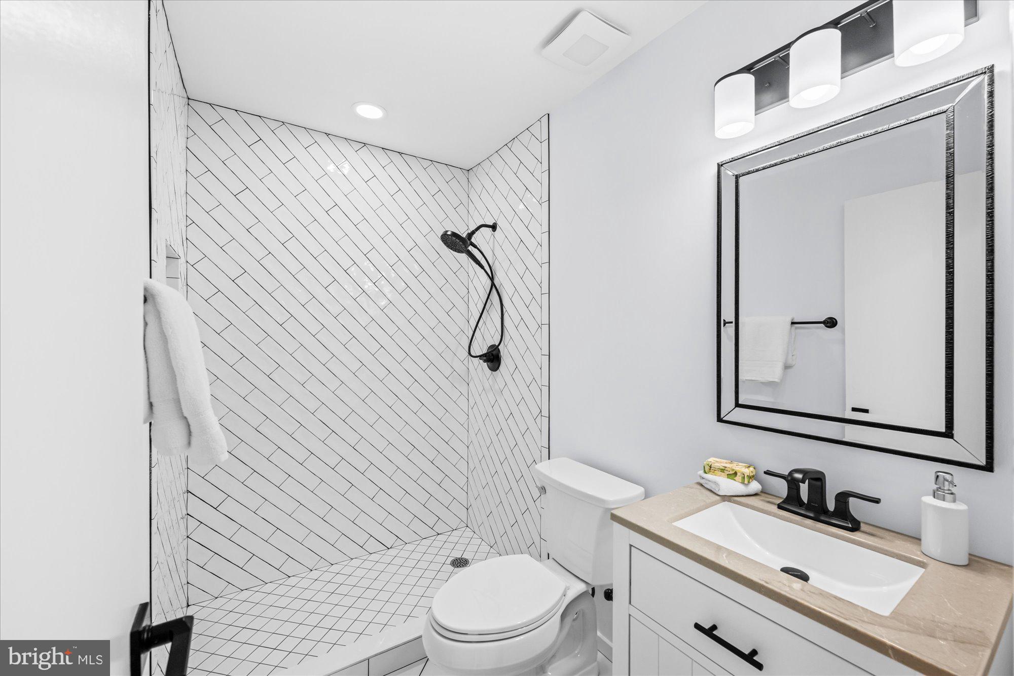 1431 Greenmont Court Reston, VA 20190 - Photo 11 of 16 a bathroom with a sink a toilet and shower