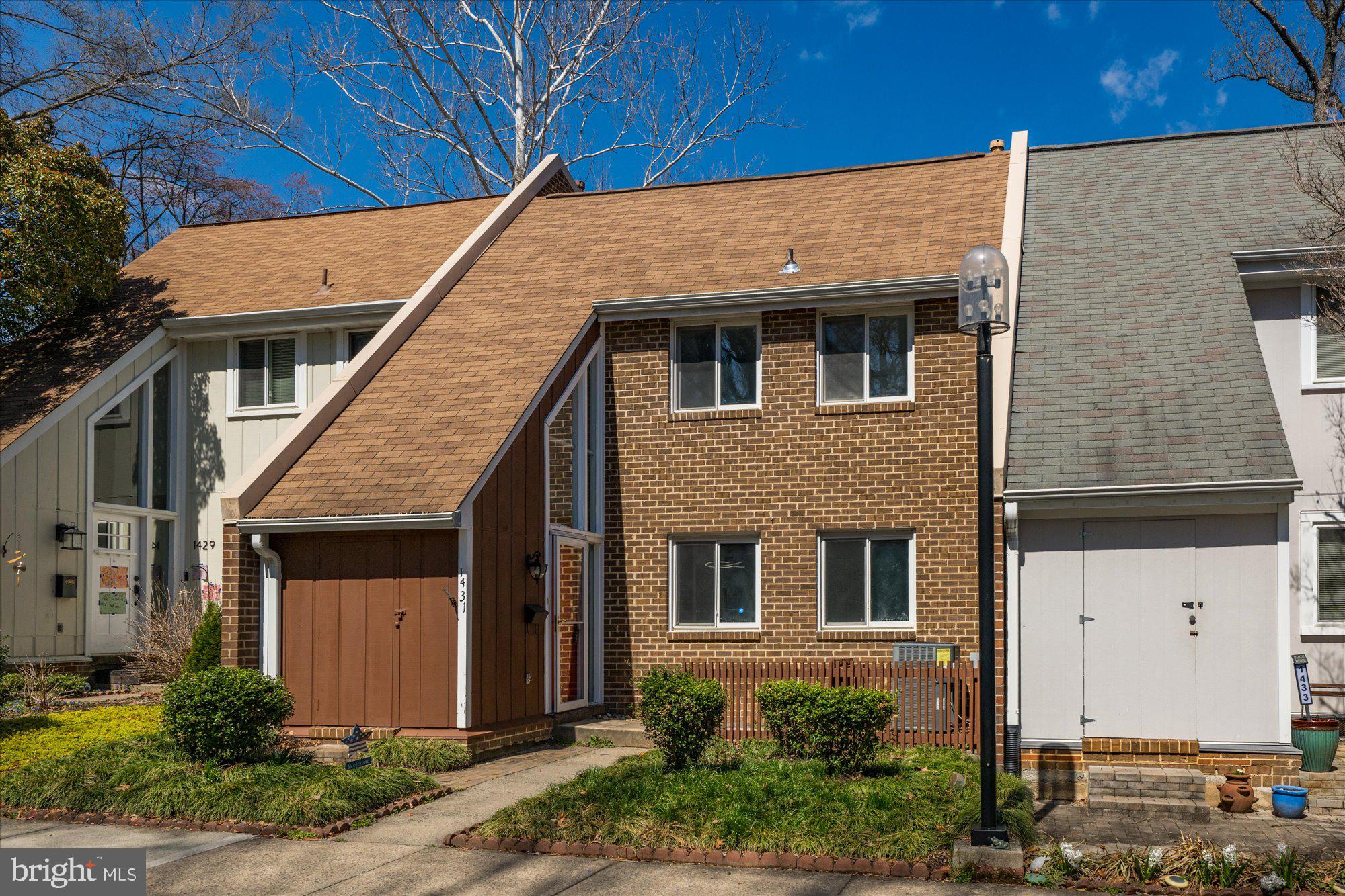 1431 Greenmont Court Reston, VA 20190 - Photo 13 of 16 a front view of a house with a yard