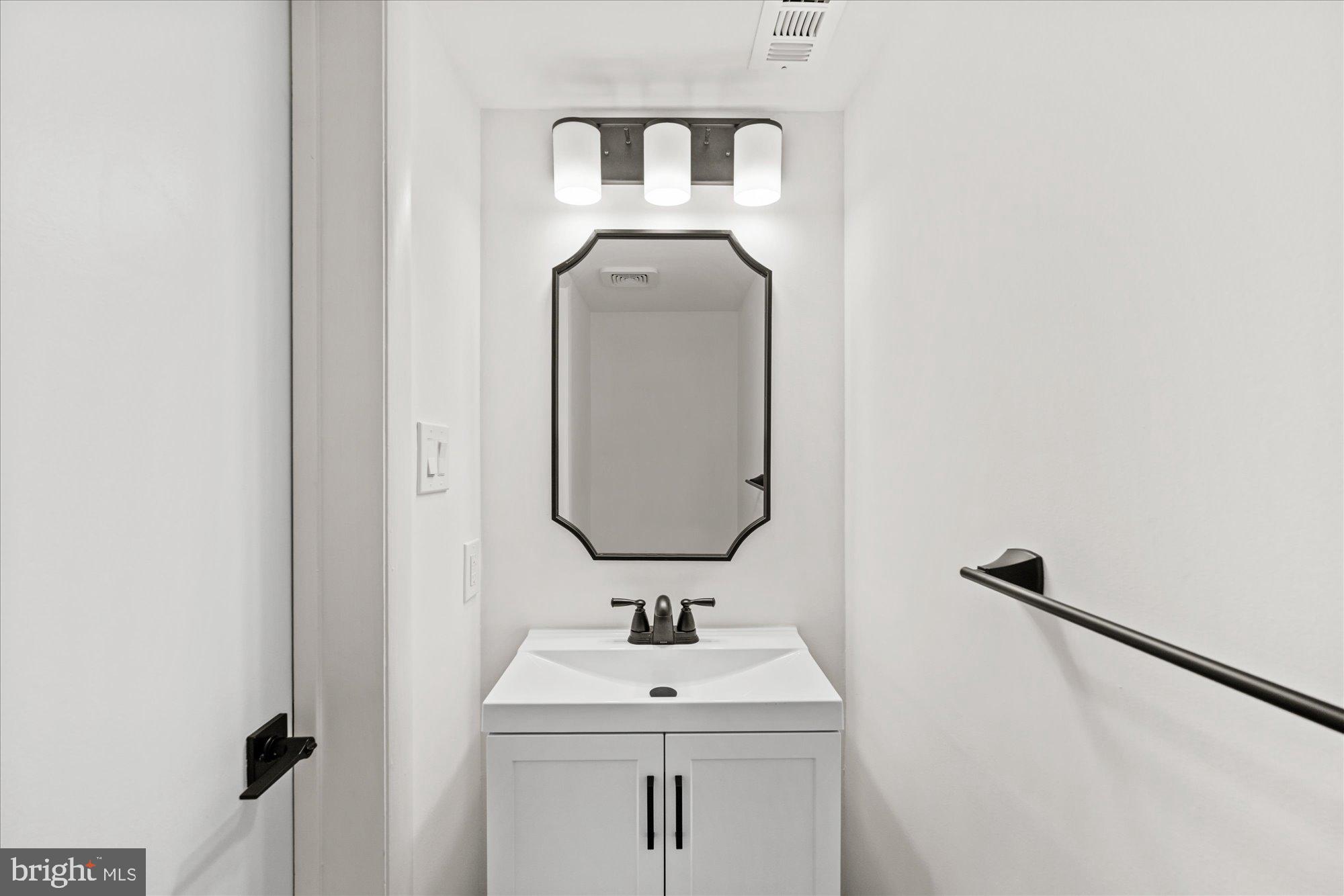 1431 Greenmont Court Reston, VA 20190 - Photo 7 of 16 a bathroom with a sink and mirror