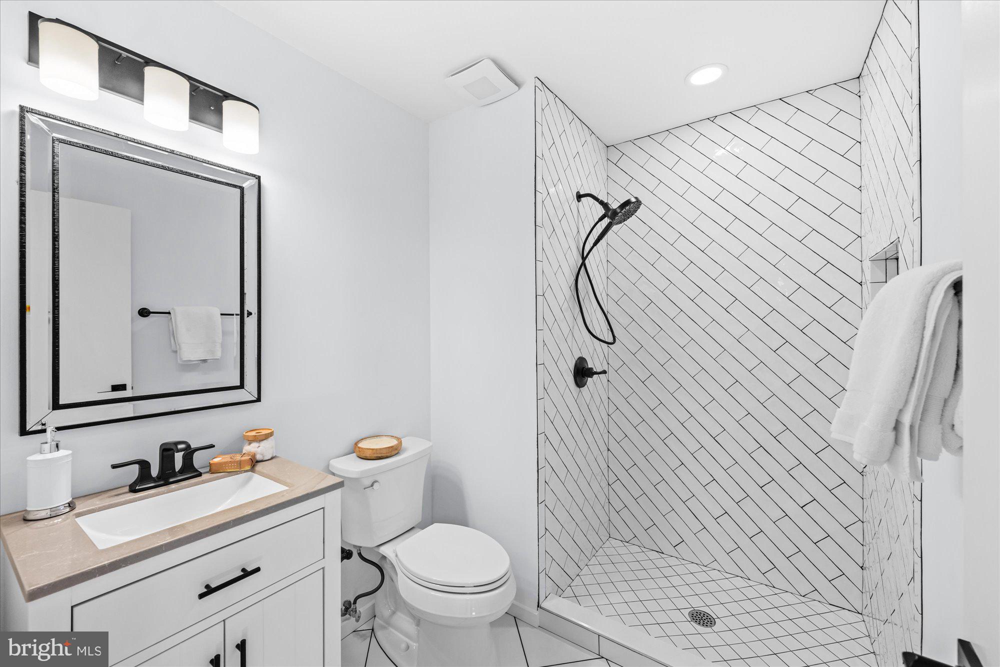 1431 Greenmont Court Reston, VA 20190 - Photo 9 of 16 a bathroom with a sink a toilet and shower