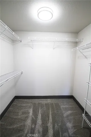 a bedroom with bed and a potted plant