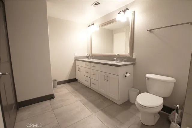 a bathroom with a bathtub sink mirror and toilet