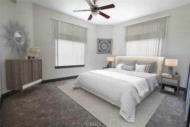 a bathroom with a granite countertop toilet a sink and a mirror