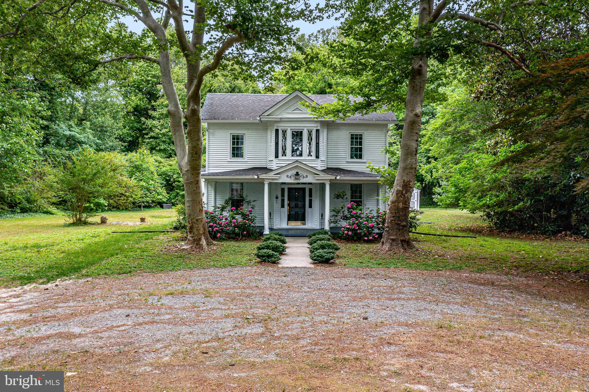 3952 Irvington Road Irvington, VA 22480 - Photo 54 of 77 a front view of a house with garden and trees
