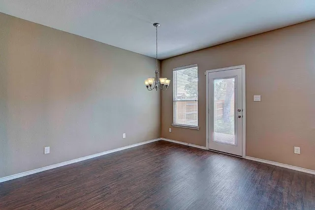 a view of a room with wooden floor and windows