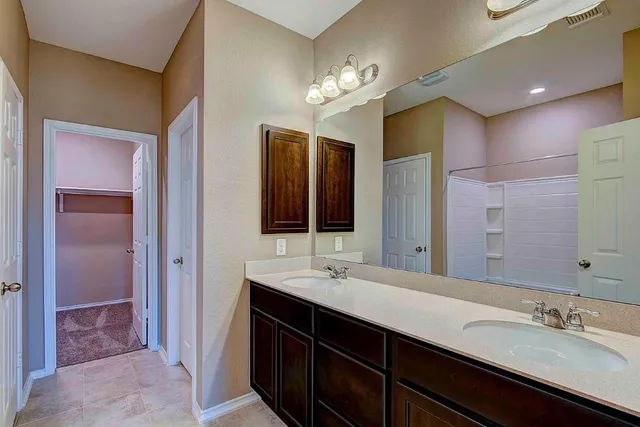a bathroom with a sink double vanity and a shower