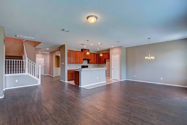 a view of a kitchen with wooden floor and a sink