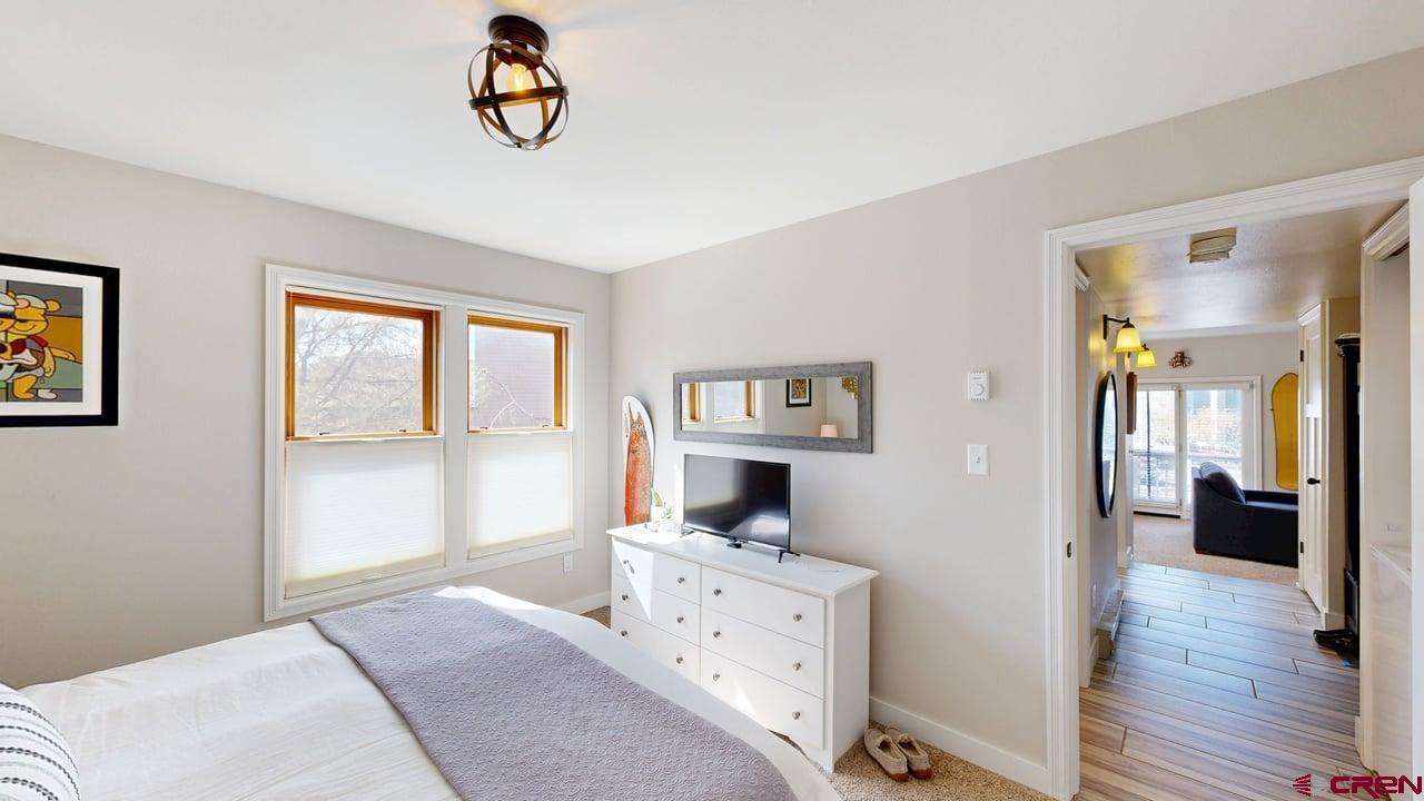 6 Ferringway Circle, Unit 47 Durango, CO 81301 - Photo 12 of 20 a bedroom with a bed and wooden floor
