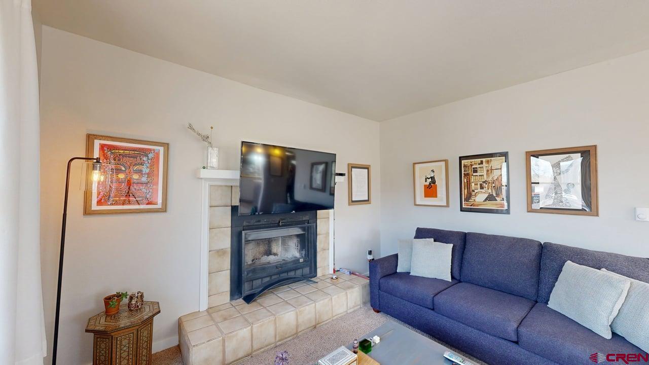 6 Ferringway Circle, Unit 47 Durango, CO 81301 - Photo 3 of 20 a living room with furniture a flat screen tv and a fireplace