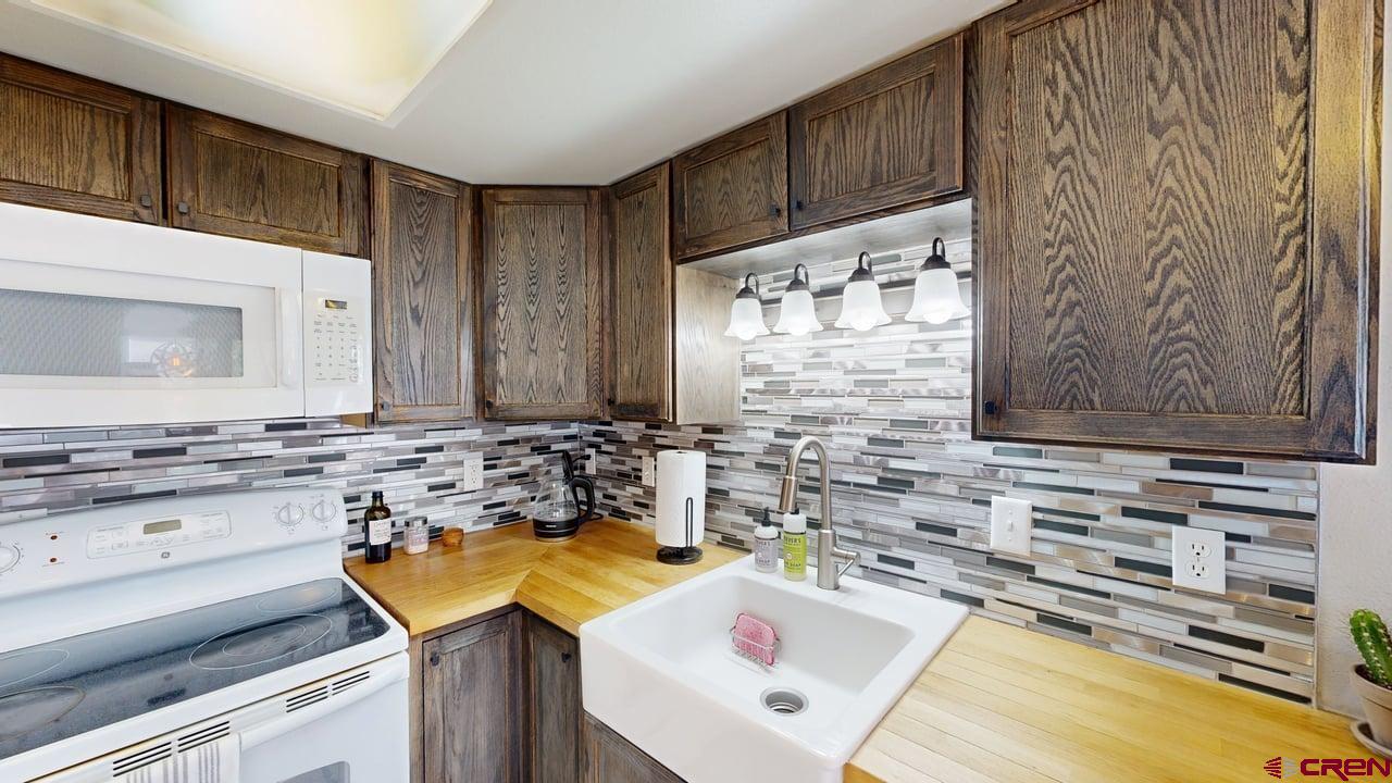 6 Ferringway Circle, Unit 47 Durango, CO 81301 - Photo 9 of 20 a kitchen with a sink and a stove top oven