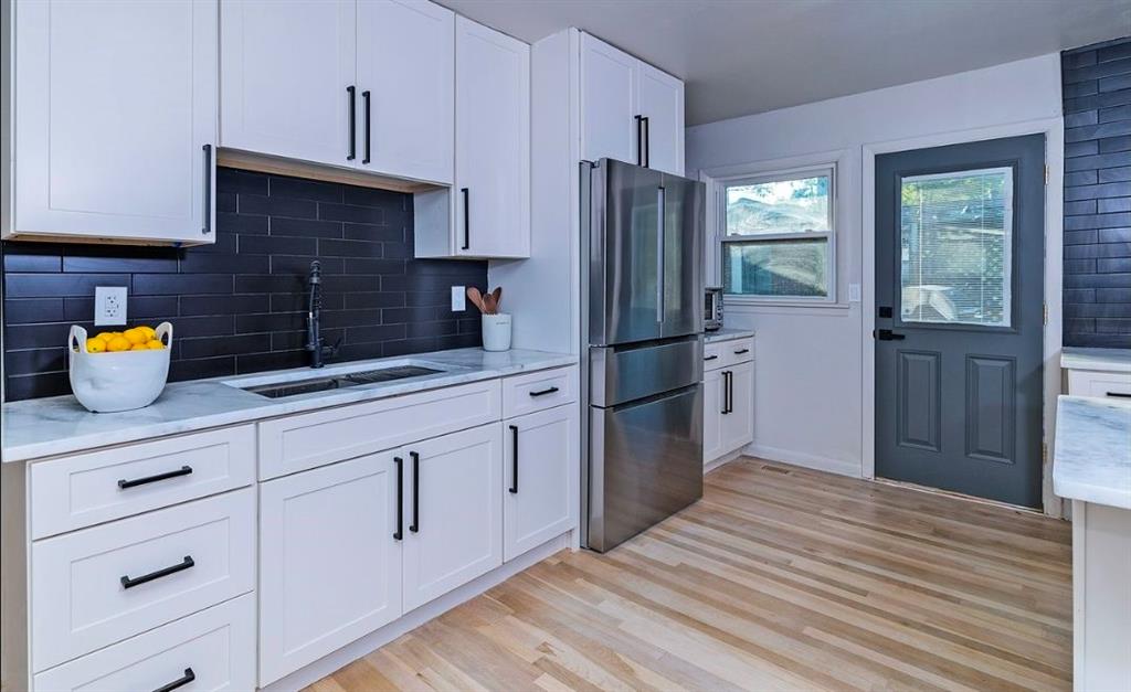 3807 Greenhill Drive Atlanta, GA 30341 - Photo 12 of 18 a kitchen with stainless steel appliances a refrigerator sink and cabinets