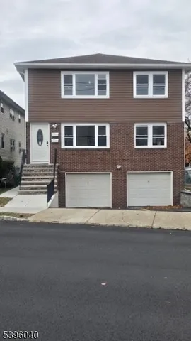 a front view of a house with a road