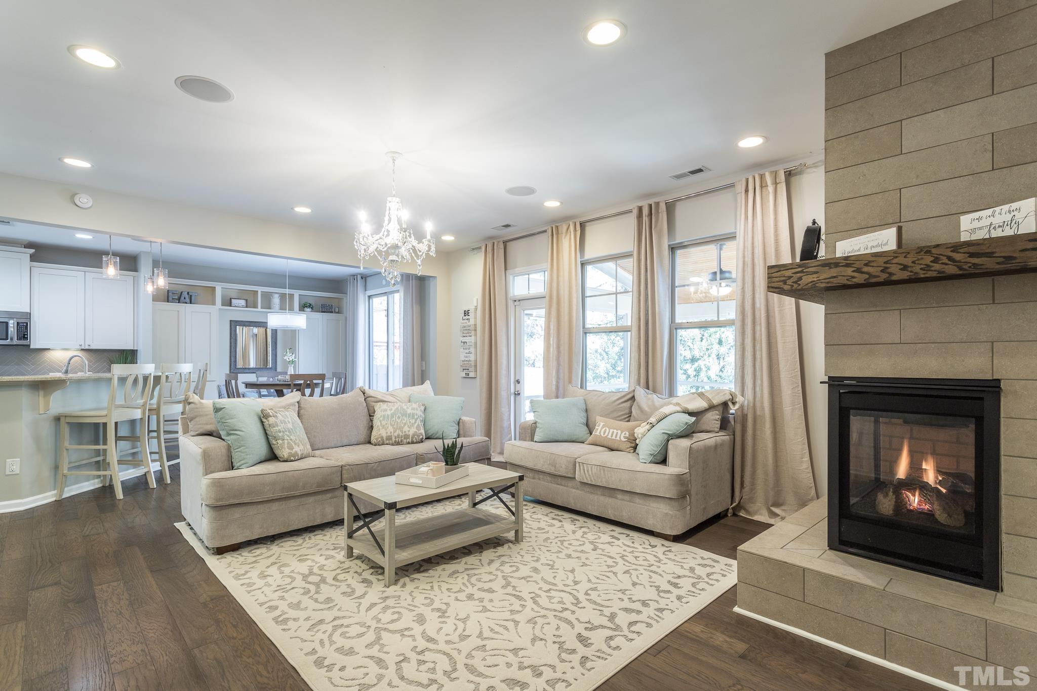 826 Wickham Ridge Road Apex, NC 27539 - Photo 17 of 47 a living room with furniture and a fireplace