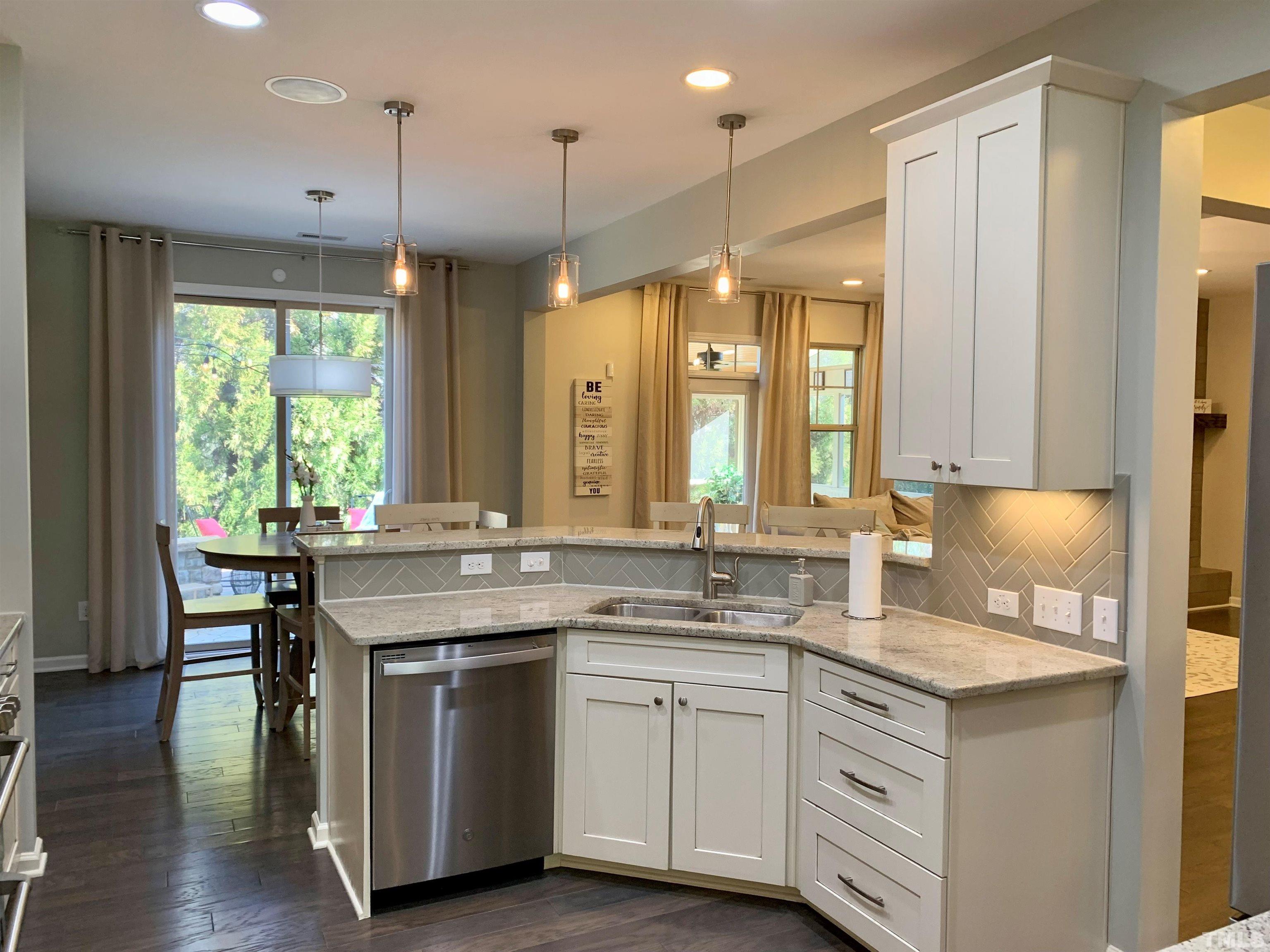 826 Wickham Ridge Road Apex, NC 27539 - Photo 3 of 47 a kitchen with a sink stove and cabinets