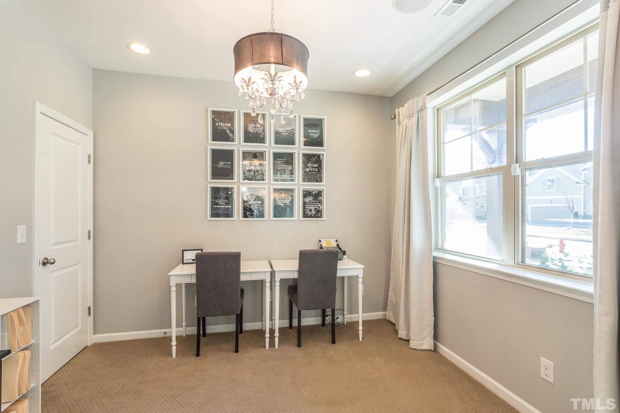 826 Wickham Ridge Road Apex, NC 27539 - Photo 7 of 47 a view of a dining room with furniture chandelier and a window
