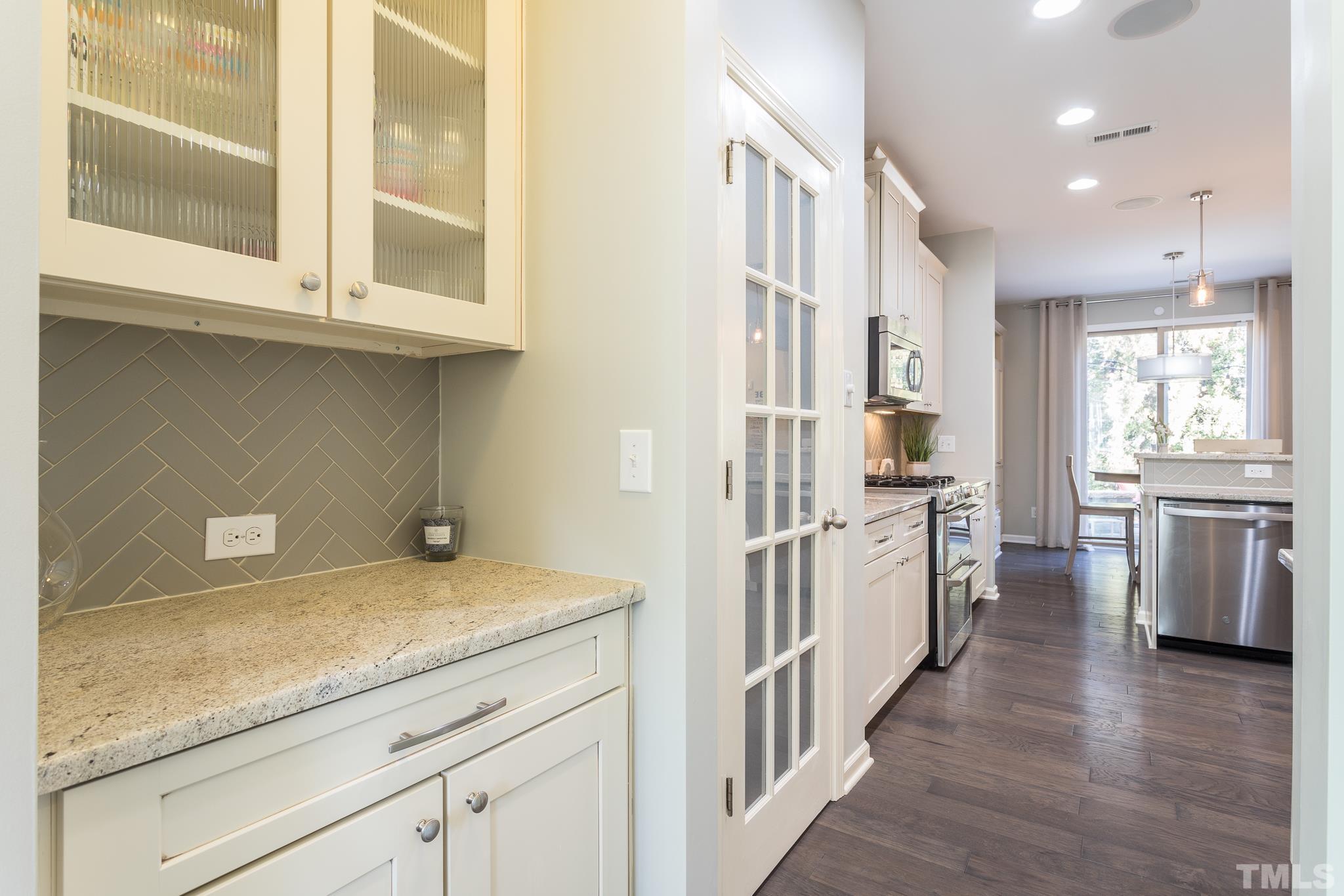 826 Wickham Ridge Road Apex, NC 27539 - Photo 8 of 47 a view of a kitchen with a sink and dishwasher a refrigerator with wooden floor