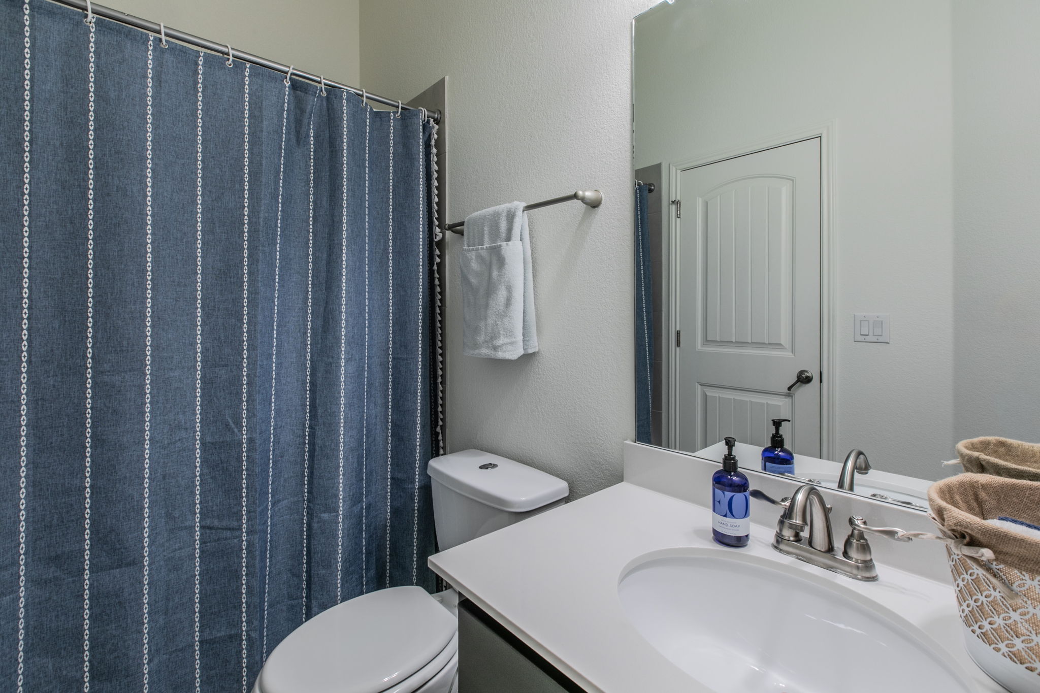 231 Simon Kyle, TX 78640 - Photo 19 of 29 Bathroom featuring a vanity with an integrated sink, brushed nickel faucet, and a large wall-mounted mirror