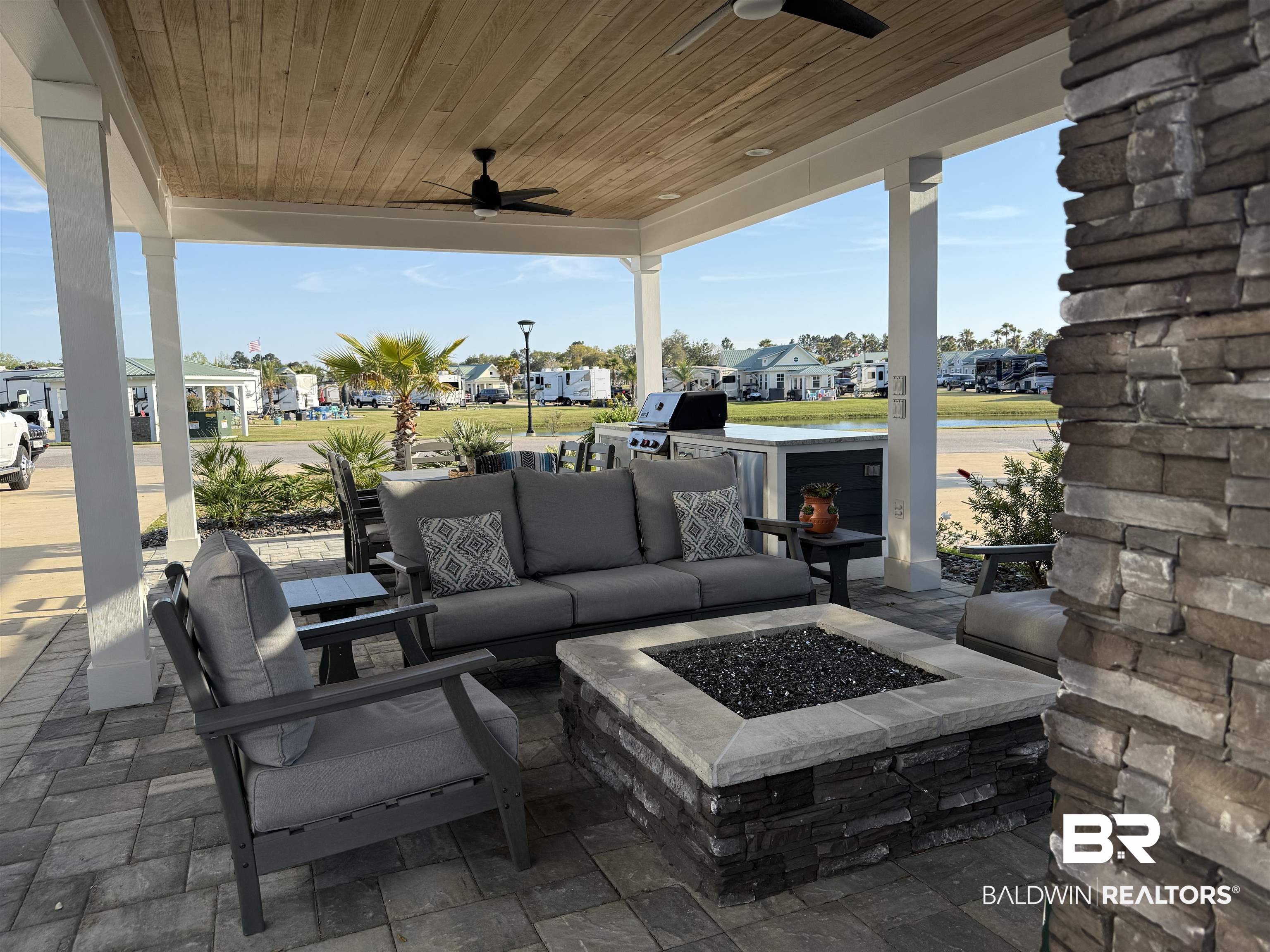 12377 Gateway Drive Elberta, AL 36530 - Photo 17 of 64 View of patio with ceiling fan, a residential view, an outdoor living space with a fire pit, and area for grilling