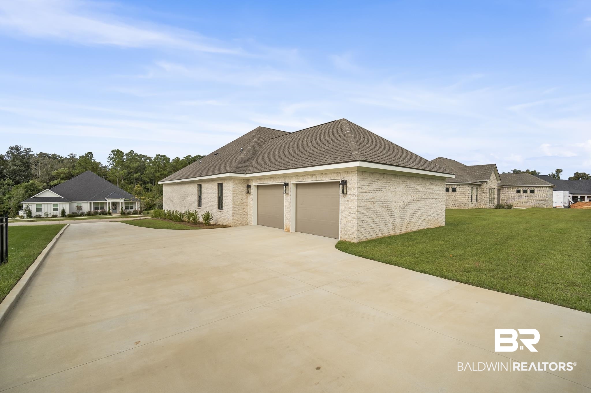 21826 Veranda Boulevard Fairhope, AL 36532 - Photo 34 of 42 View of side of home with a lawn, brick, roof with shingles, and concrete driveway