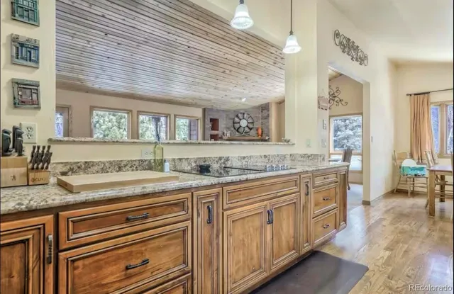 a spacious bathroom with a granite countertop sink and a mirror