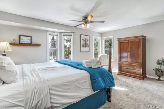 a bed room with a bed and a chandelier