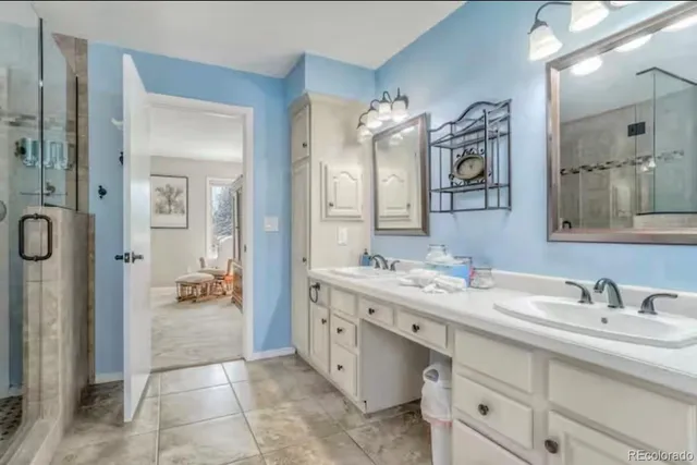 a spacious bathroom with a granite countertop sink mirror and shower