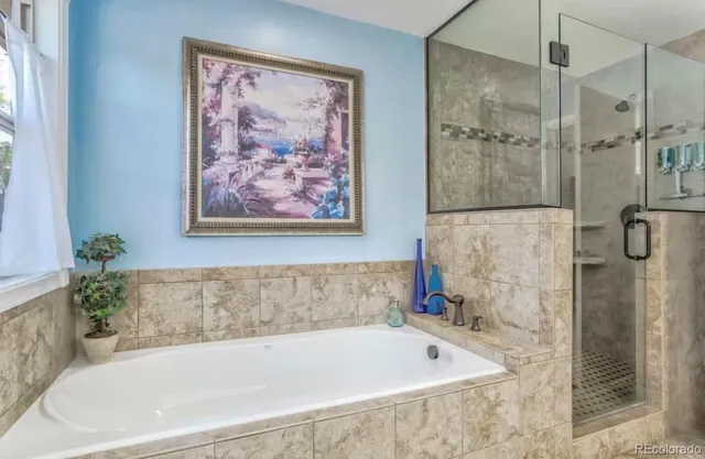 a bathroom with a bathtub and shower