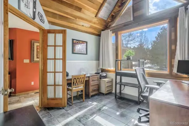 a work room with furniture and large windows