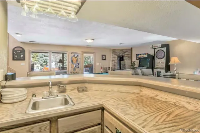 a view of a kitchen with kitchen island and a sink