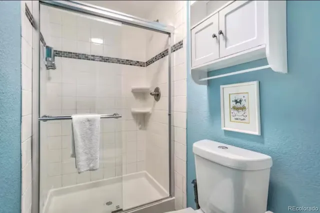 a bathroom with a shower and mirror