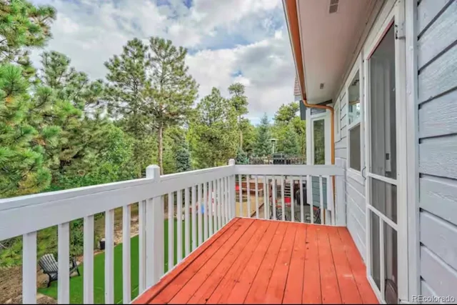 a balcony with wooden floor and fence