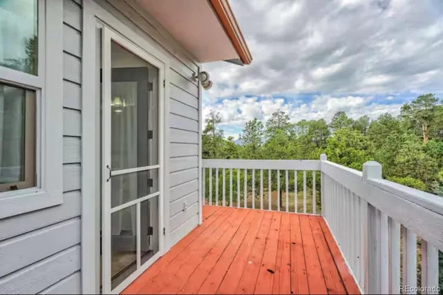 a view of balcony with wooden floor and fence