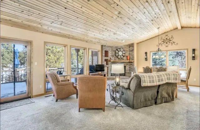 a living room with furniture and a floor to ceiling window