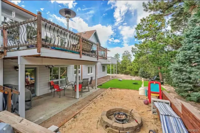 an outdoor living area with furniture and a potted plant