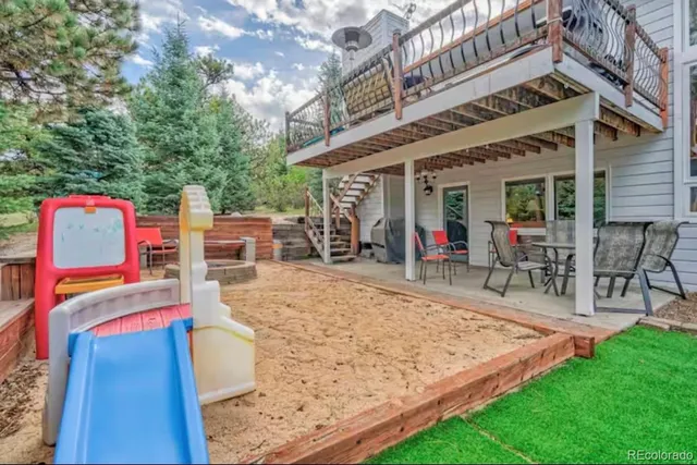 a view of a backyard with a patio and fire pit