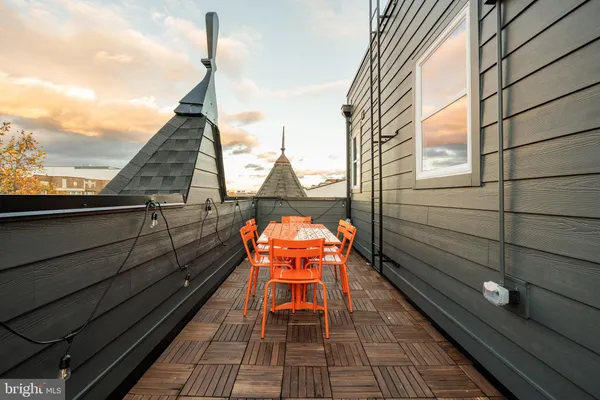 a sitting area with wooden floor