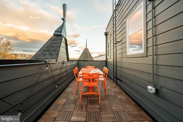 a sitting area with wooden floor