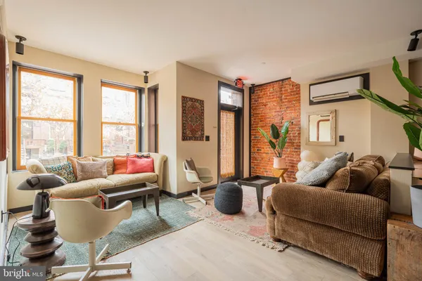 a living room with furniture and a floor to ceiling window