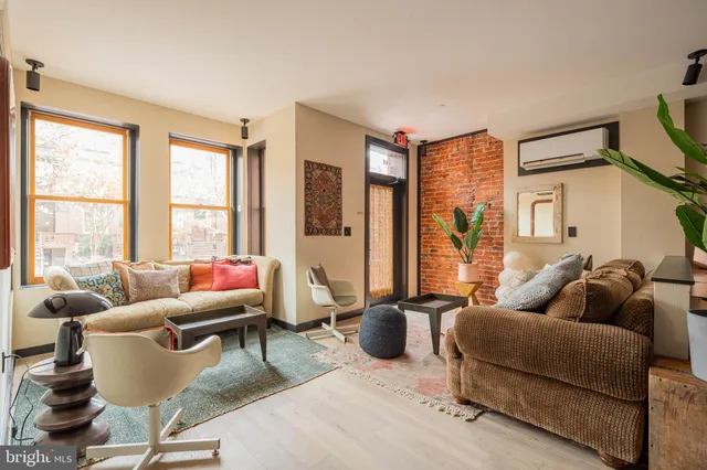 a living room with furniture and a floor to ceiling window