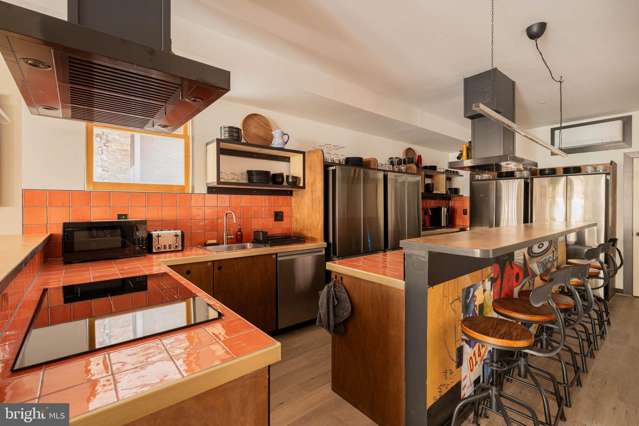 1480 Chapin Street Northwest, Unit 4 1 Washington, DC 20009 - Photo 21 of 23 a kitchen with stainless steel appliances granite countertop a sink and a refrigerator