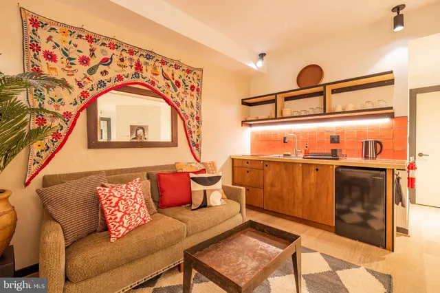 a living room with a couch and dresser